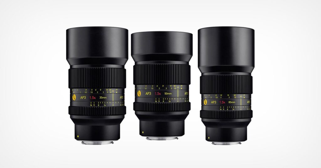 Cooke Brings its Anamorphic Lens Legacy to Mirrorless Cameras Three black camera lenses with yellow and white markings are standing upright side by side against a plain white background. Each lens displays different focal lengths and aperture information on their barrels.