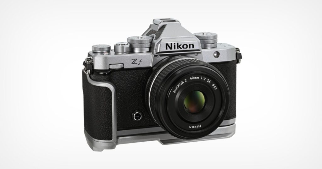 A Nikon Z f mirrorless digital camera with a retro silver and black design, shown with a NIKKOR Z 40mm f/2 SE lens attached, against a plain white background.