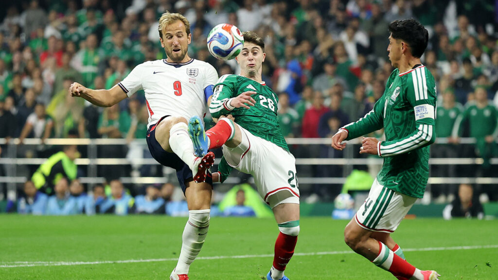 Harry Kane #9 of England competes for the ball against Brian Gutierrez #26 of Mexico during the FIFA World Cup 2026 Round of 16 match between Mexico and England at Mexico City Stadium on July 05, 2026 in Mexico City, Mexico.