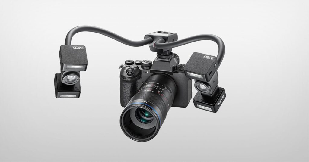 A digital camera with a macro lens is mounted with a dual-arm lighting system featuring two Godox MF-R76-style flash units.
