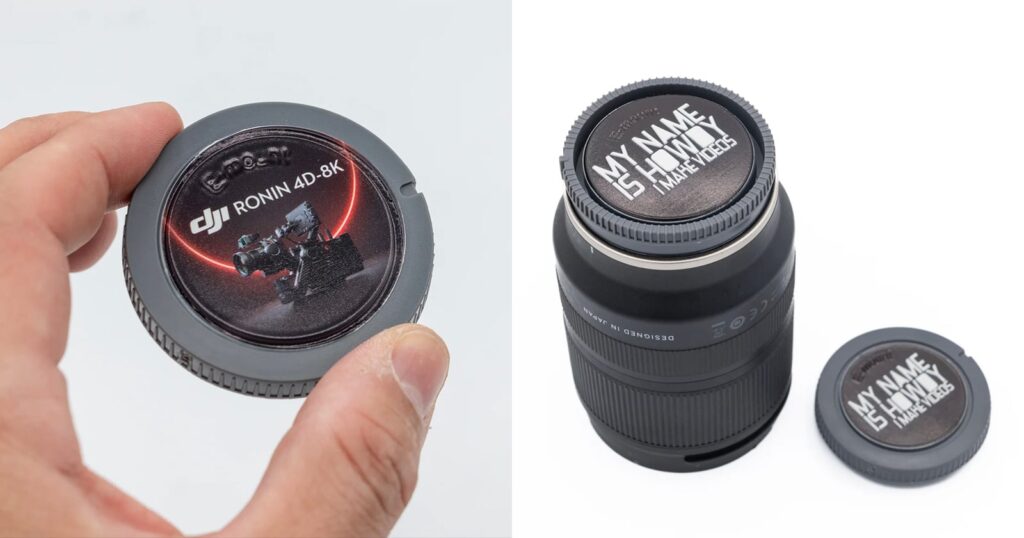 These Custom Camera Caps Turn Your Gear Into a Branding Opportunity A hand holds a gray camera body cap with a DJI Ronin 4D-8K sticker, next to a camera lens with a custom "MY NAME IS HOWDY I MAKE VIDEOS" cap.