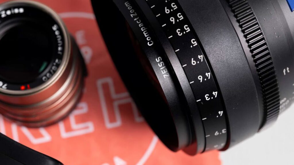 Zeiss lenses on a white surface next to a KEH lens cloth
