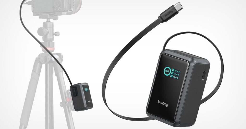 SmallRig Nano Power Banks Have Mounting Points for Camera Rigs A SmallRig power bank with a digital display showing battery percentage and port wattage is shown next to a camera mounted on a tripod, with a cable connecting the two.