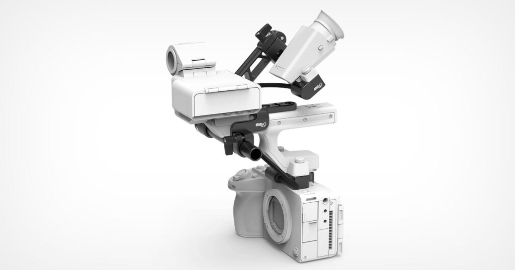 Third-Party Companies Are Fixing One of the Sony FX5’s Few Flaws A white camera rig featuring a top handle, a battery mount, and an electronic viewfinder attached to a camera body on a white background.