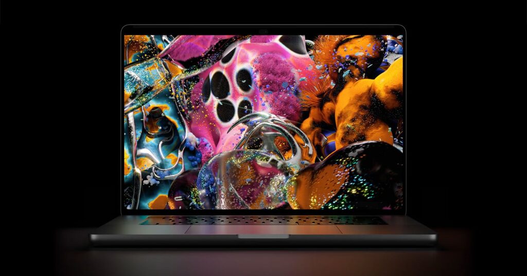 A laptop with a dark frame displays a vibrant, abstract digital artwork featuring colorful, textured, and metallic shapes.