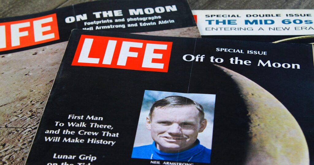 Three vintage LIFE magazine covers are arranged on a wooden surface, featuring headlines and imagery related to the Apollo moon landings and the 1960s.